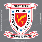 Badge-style crest reading 'FIRST TEAM PRIDE' with a red shield, blue stars, and the phrases 'DEVELOP LOYALTY' and 'PREPARE TO MARCH' on ribbons against a gray background.
